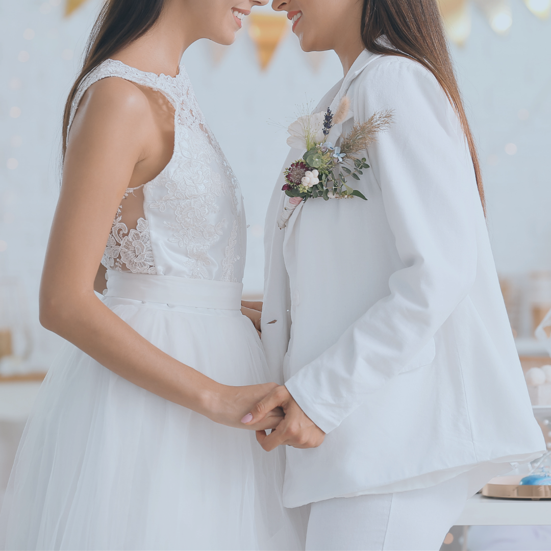 Two women holding hands on an altar