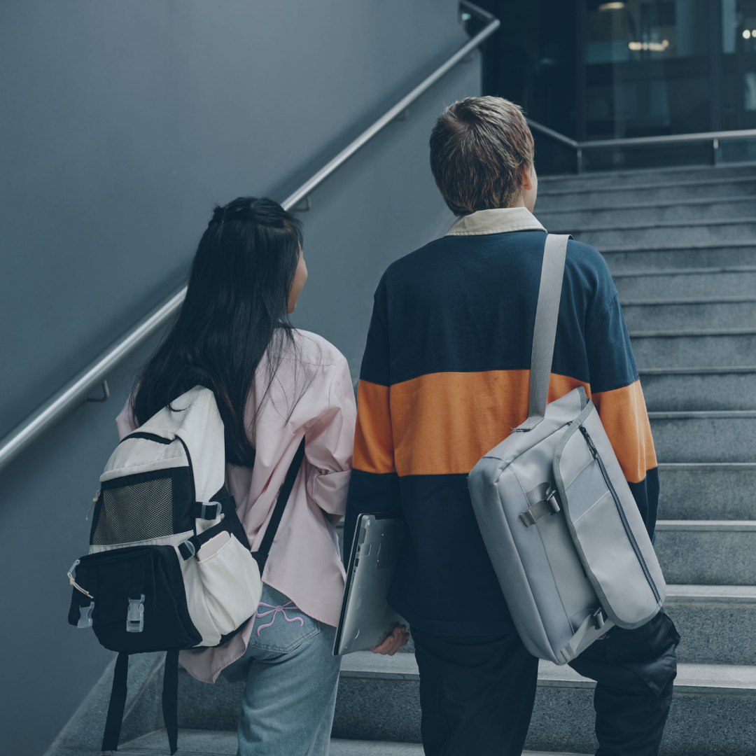 Two people going up the stairs
