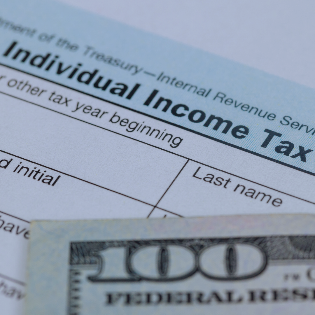Individual Income Tax document with a $100 bill