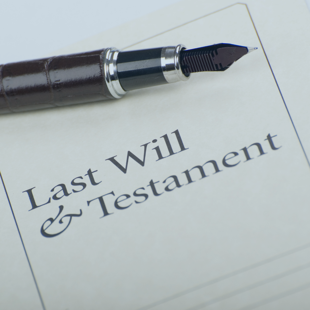 A paper with the words "Last Will & Testament" written on it and a pen