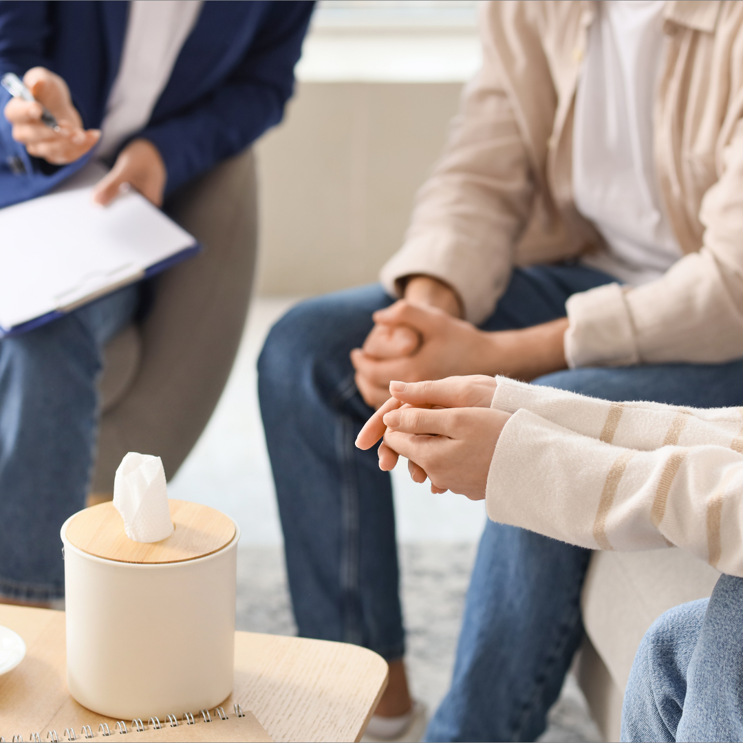 Yound Couple with Mediator Sitting in Office